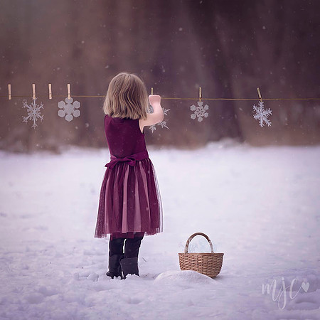 Little girl hanging snowflakes winter MJCollins Photography