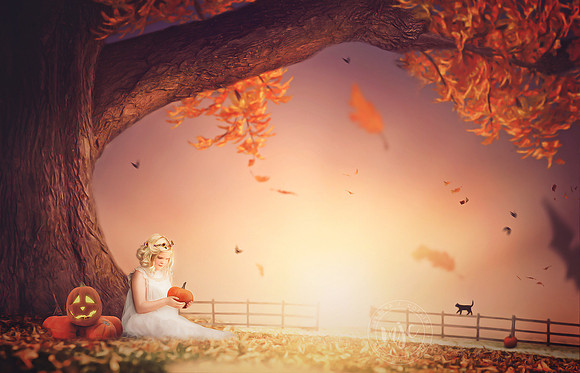 Little boy reading a book under big linden tree